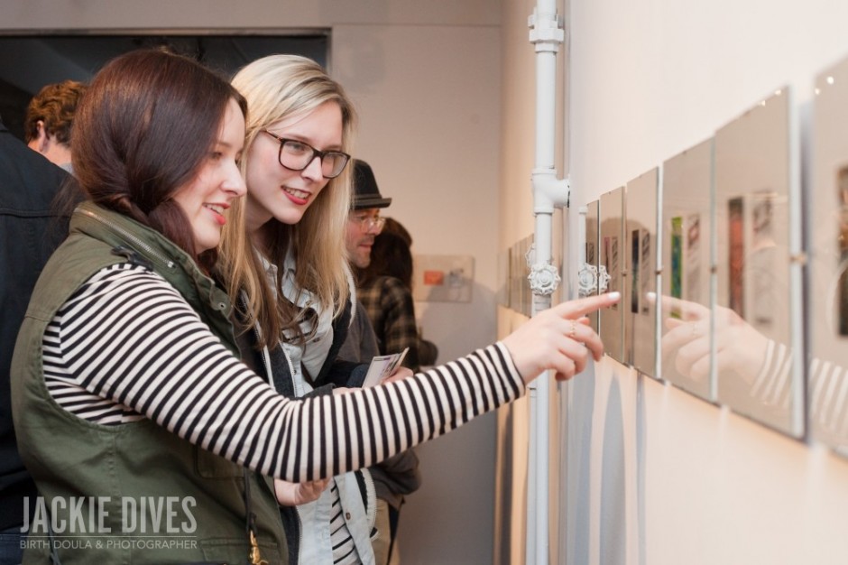 looking at the art on the wall